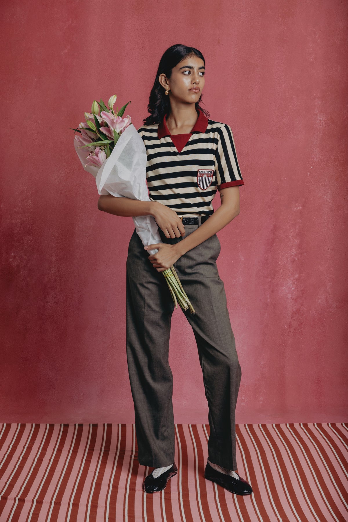 Girl wearing the Zebra striped polo shirts with a visible brand logo.