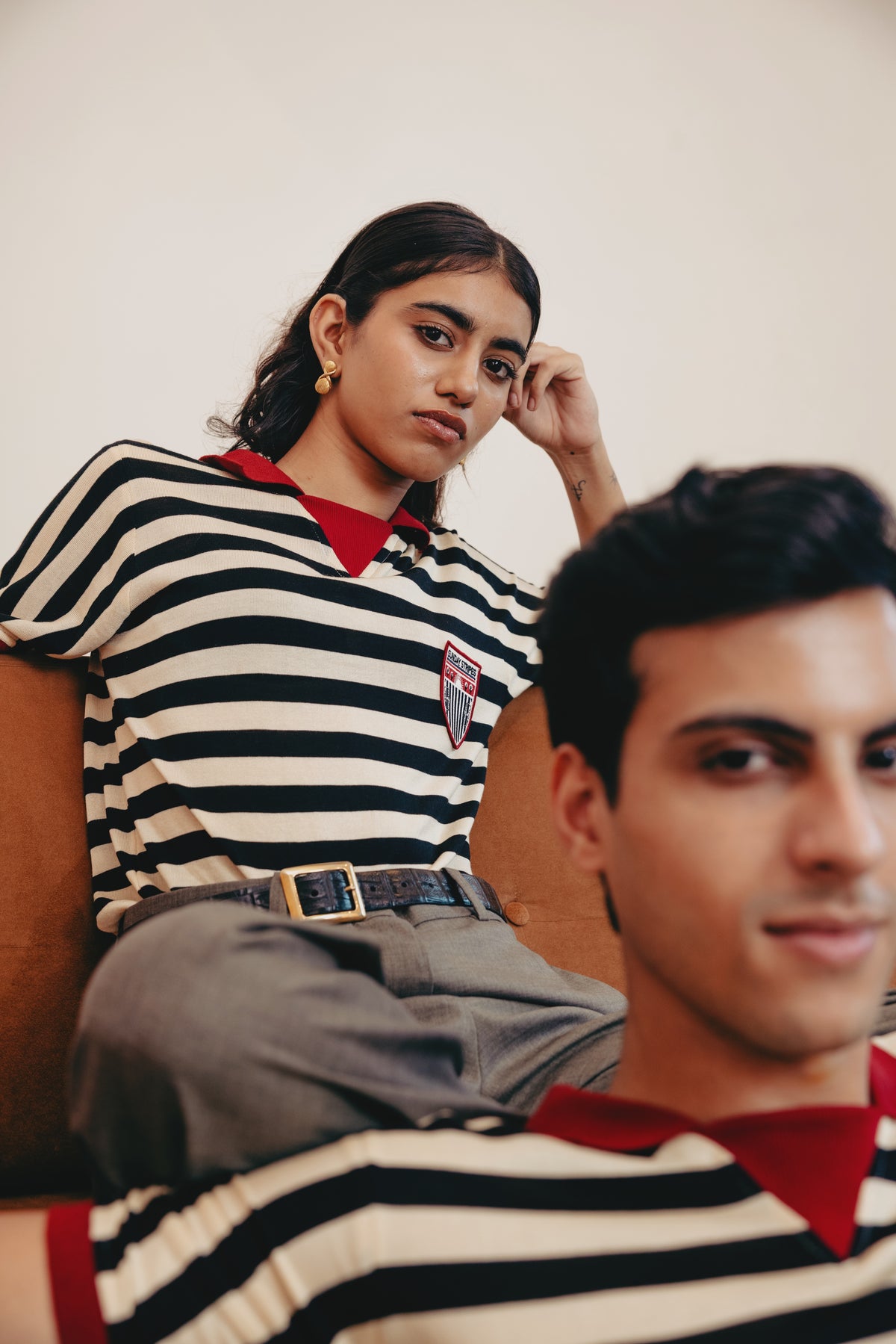 Two people wearing the Zebra striped polo shirts with a visible brand logo.