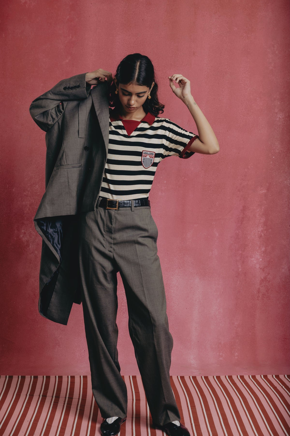 Girl wearing the Zebra striped polo shirts with a visible brand logo.