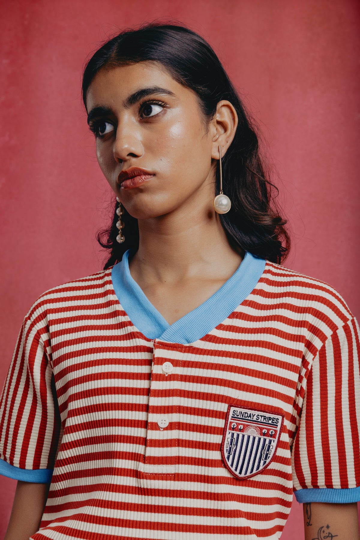 Girl wearing a red and white striped candy cane shirt with a blue collar 