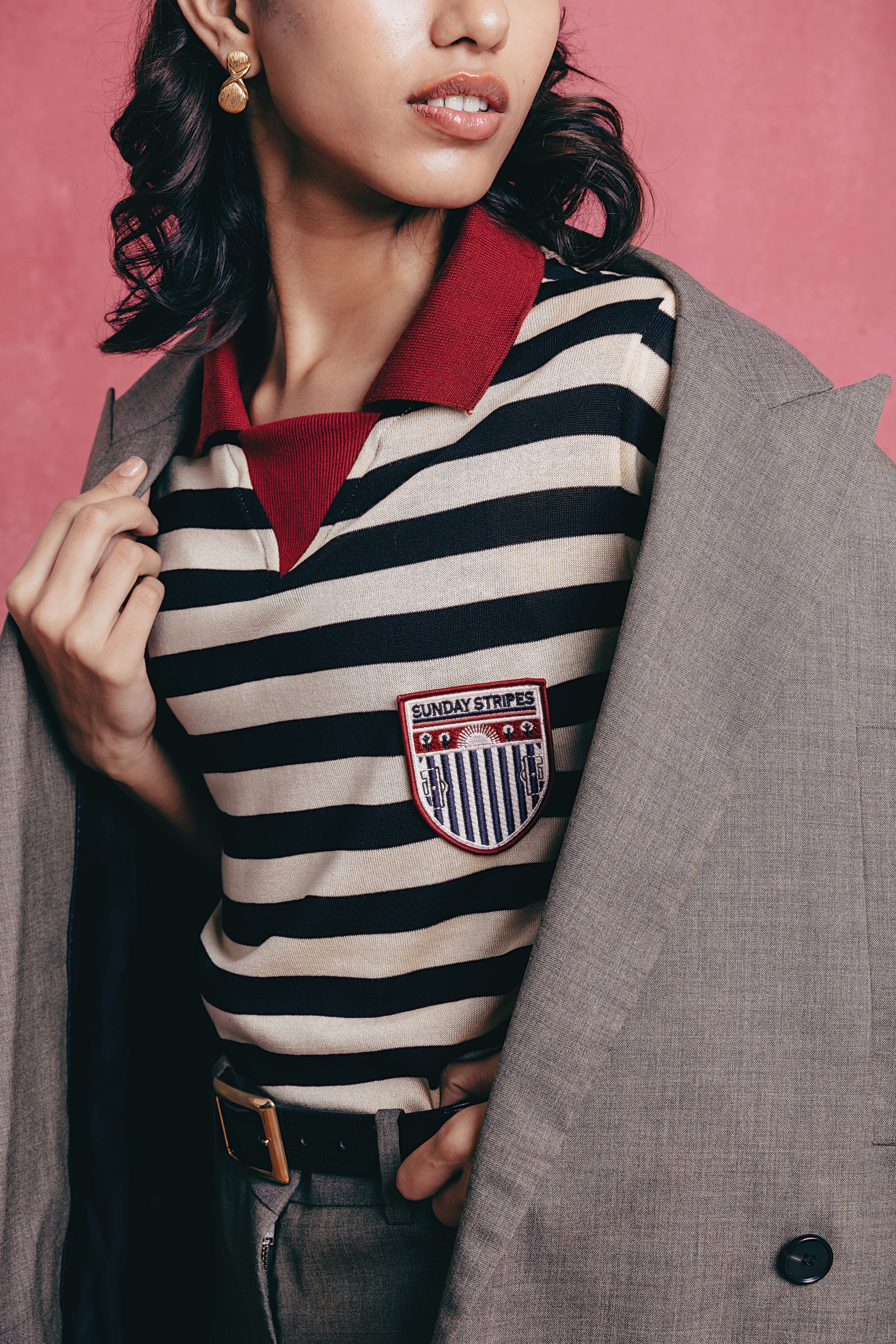 Girl wearing the Zebra striped polo shirts with a visible brand logo.