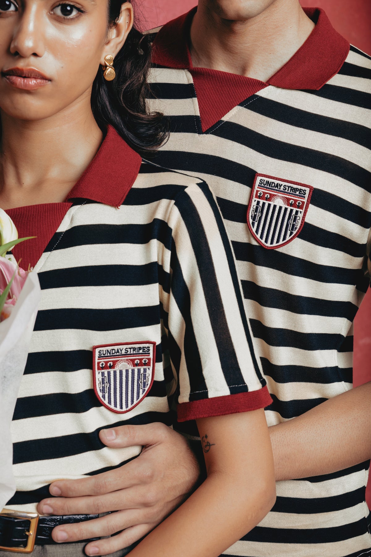 Two people wearing the Zebra striped polo shirts with a visible brand logo.
